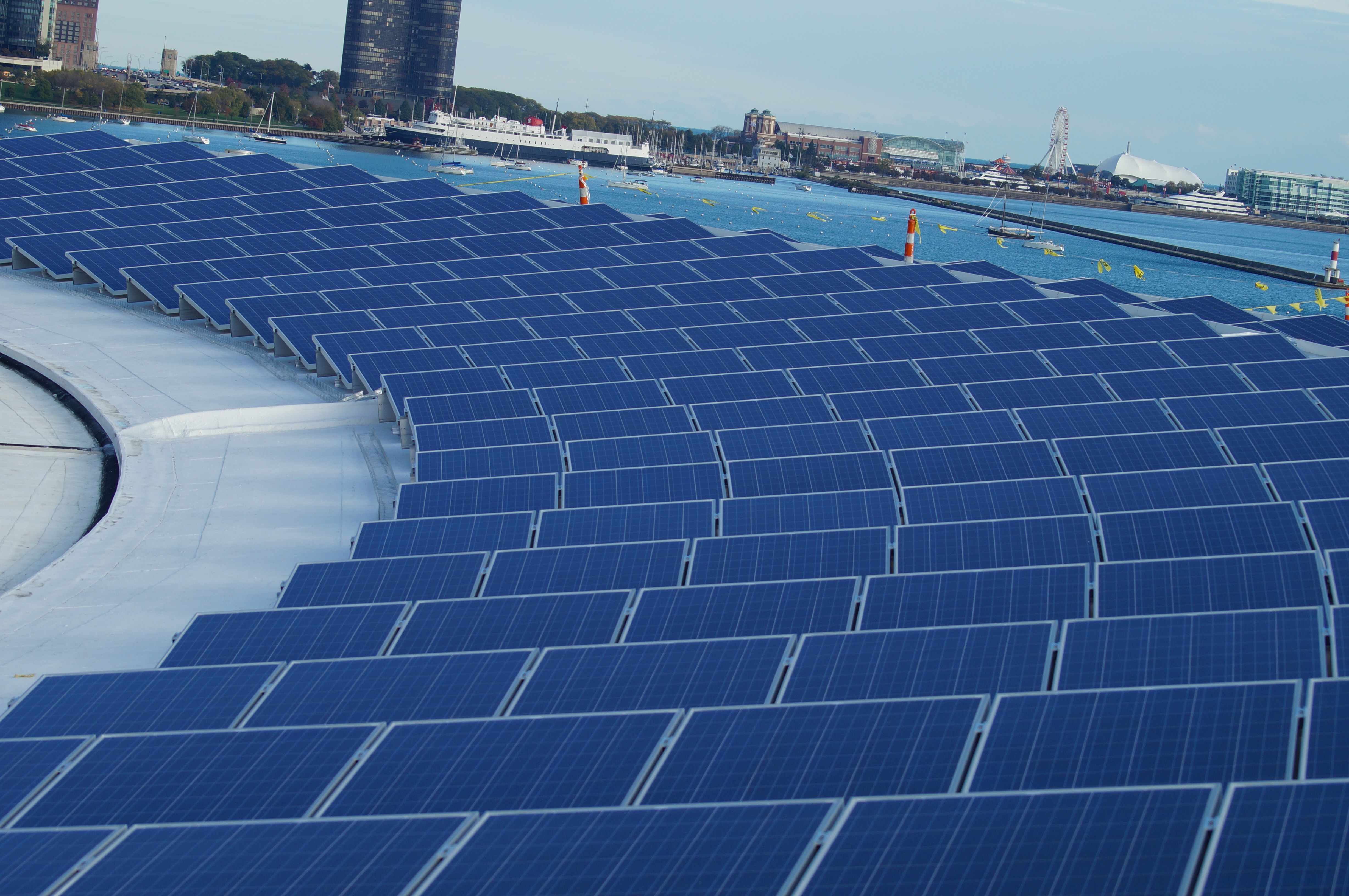 A rooftop solar array over a city waterfront