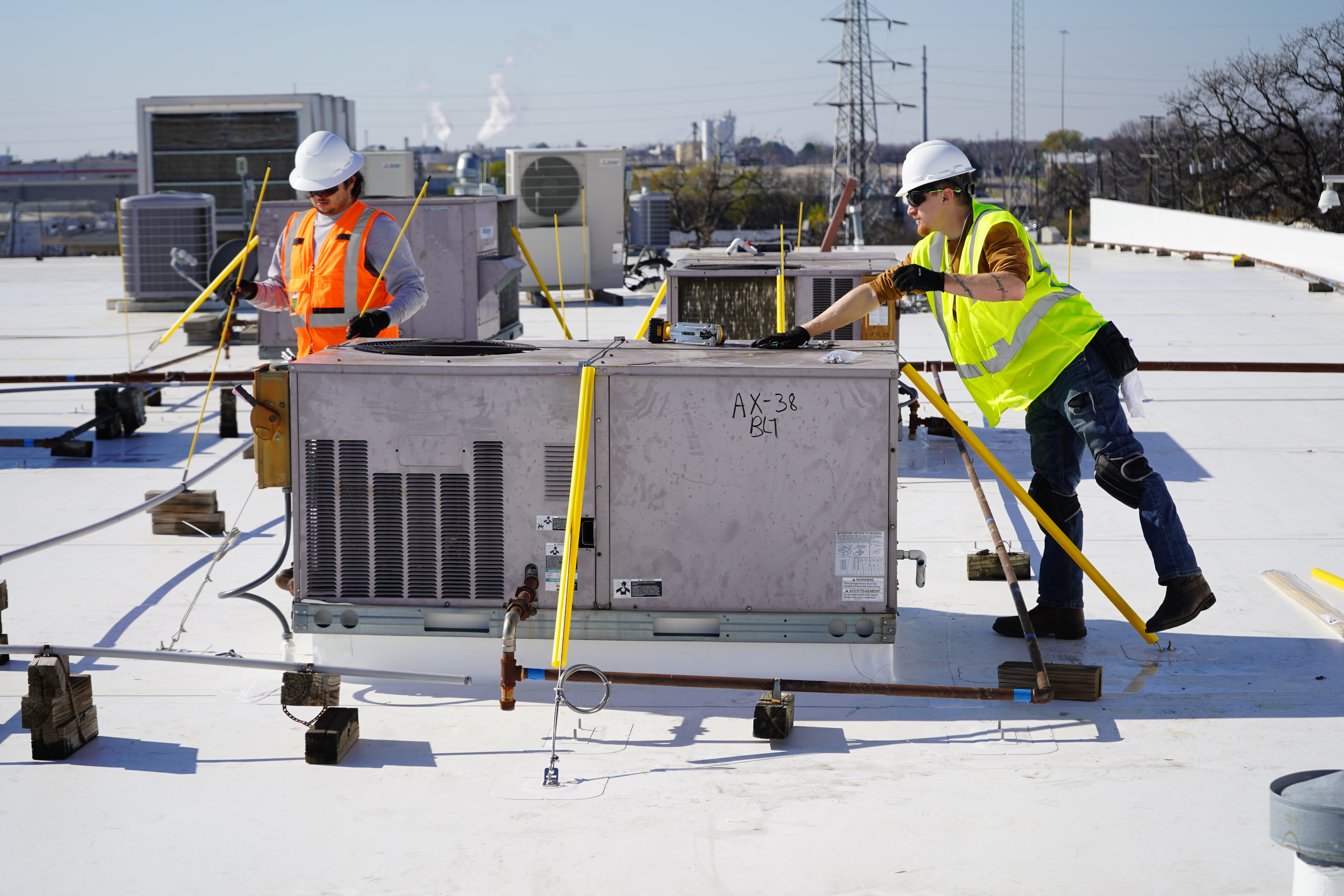 Two installers fixing a unit down to the deck