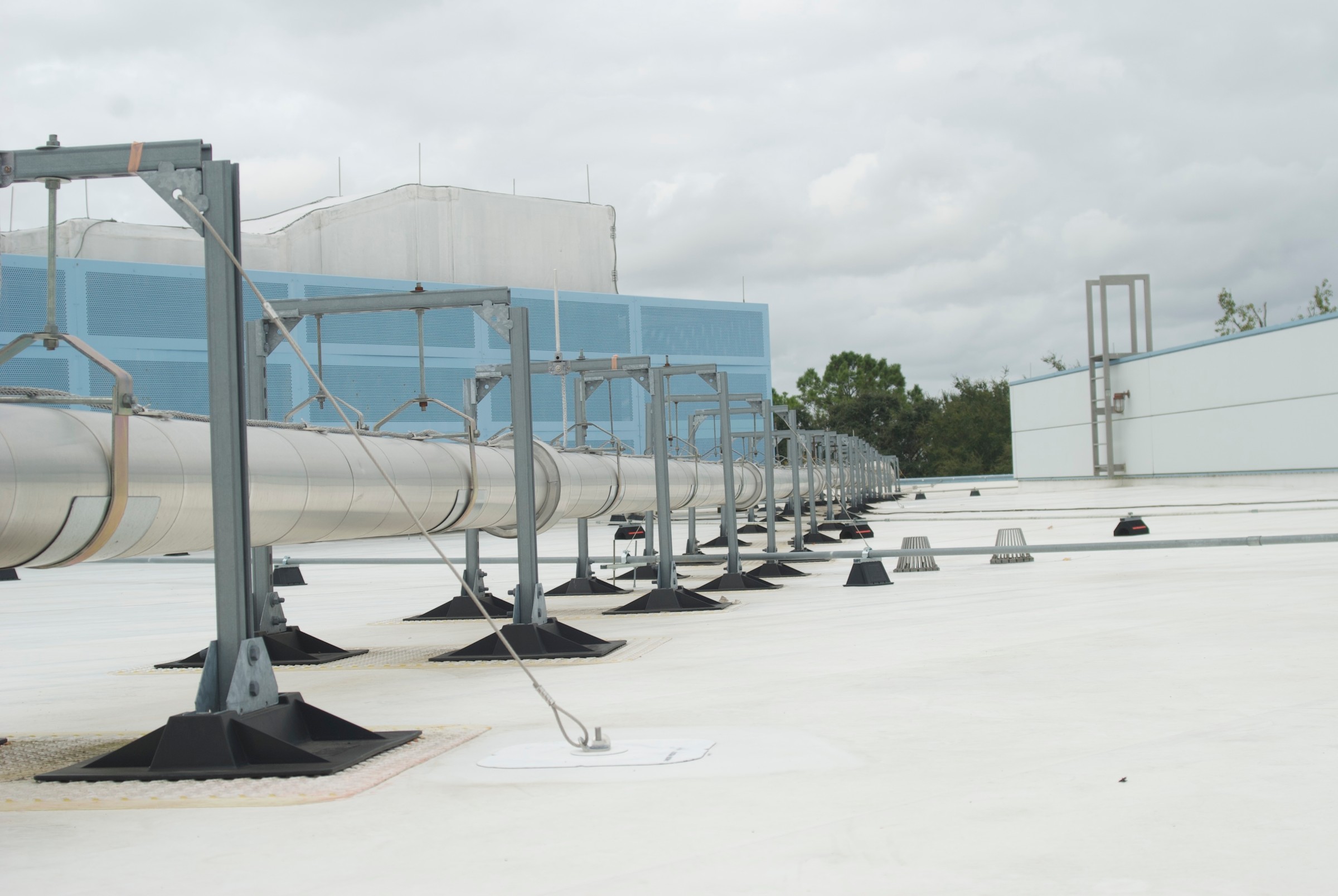 Pipe runs carried on Compression-Free™ supports across a commercial roof